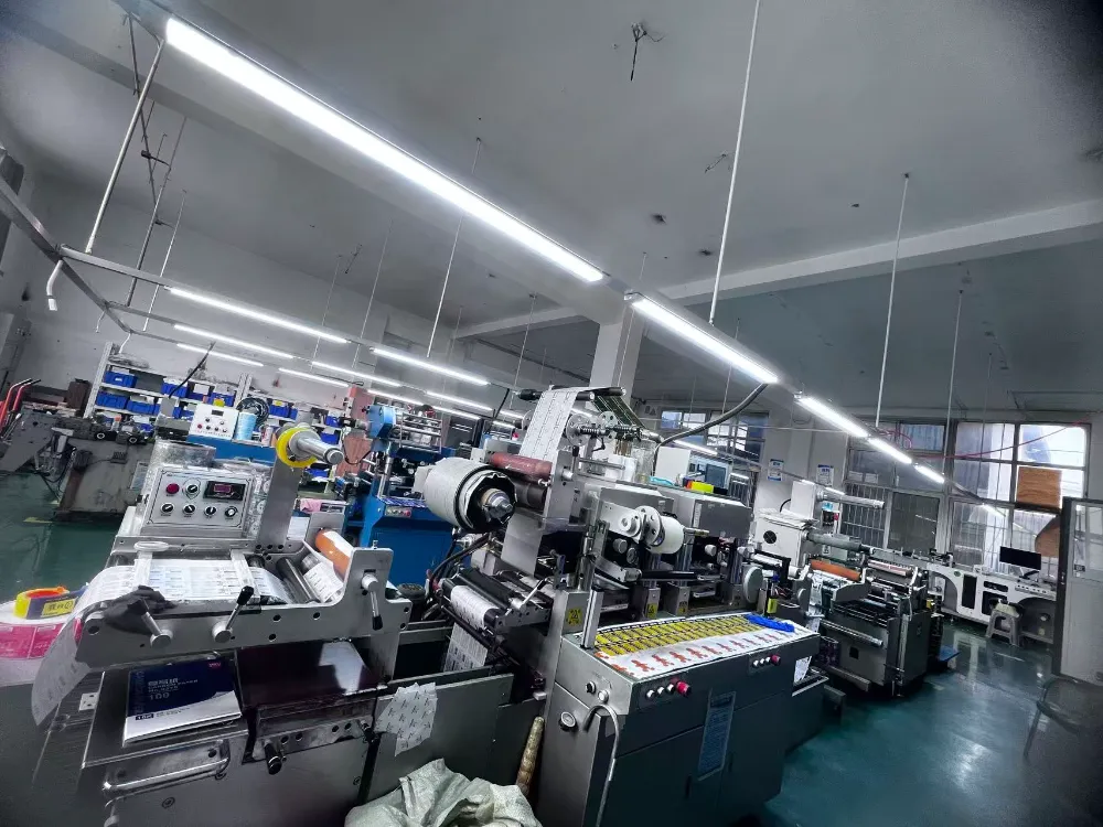 Xinsen Packaging raw material warehouse featuring premium FASSON and Lintec synthetic film rolls for label manufacturing